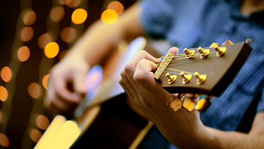Man playing guitar close up